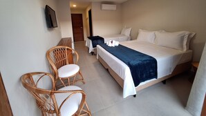 A hotel room with two beds, a desk, and a chair. - Pousada Oasis dos Ventos (Touros)