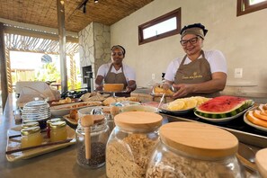 A buffet setup with various food items and condiments. - Pousada Oasis dos Ventos (Touros)