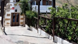 A two-story building with a small entrance and a balcony.