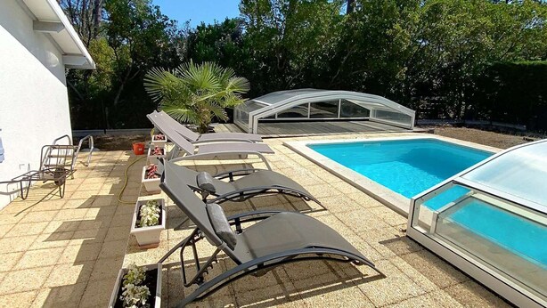 A pool area with lounge chairs and a covered seating area. - Holiday home for 6 people with pool in Lacanau Océan (LACANAU OCEAN)
