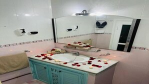 A bathroom with a sink, mirror, and cabinet.