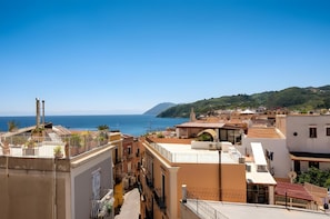 A coastal town with buildings, a clear sky, and the sea.