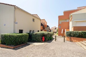 A paved street with buildings, a red mailbox, and a sign. - Apartment 'Notre Dame' with Sea View, Private Terrace and Wi-Fi (Capbreton)