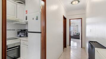 Fridge, microwave, coffee/tea maker, cookware/dishes/utensils