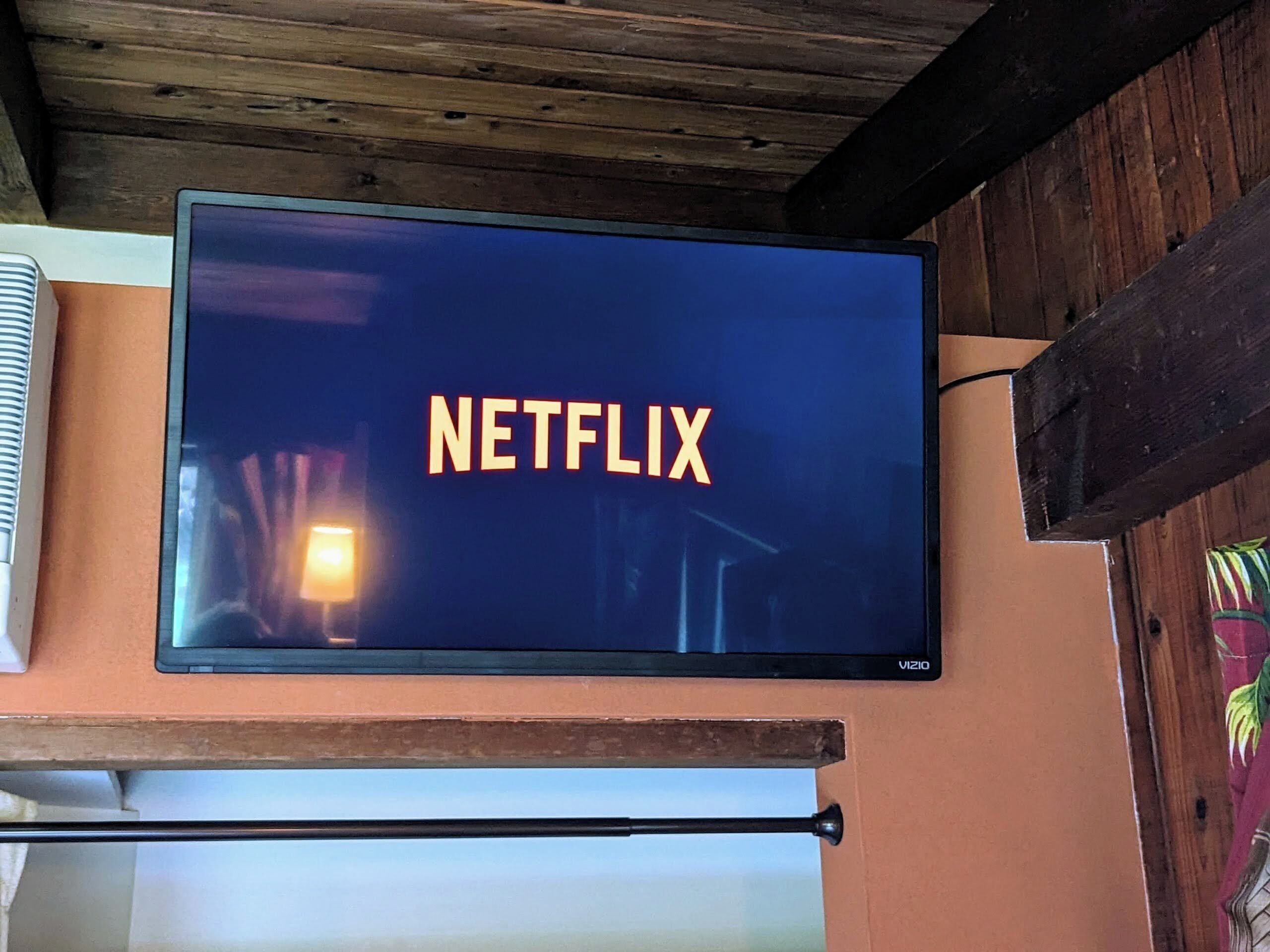 Ein an der Wand befestigter Fernseher zeigt das Netflix-Logo.