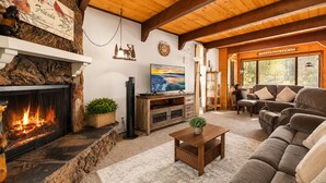 A cozy living room with a fireplace, a television, and comfortable seating.
