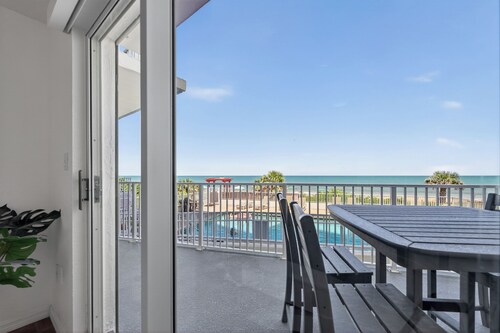 Ground floor direct oceanfront 2/2 with a balcony, heated pool, and garage parking