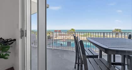 Ground floor direct oceanfront 2/2 with a balcony, heated pool, and garage parking