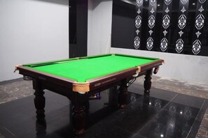 A pool table with a green felt surface, positioned on a glossy black floor. - Yun Yin Nanshan (Chongqing)