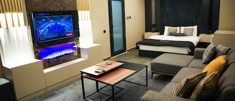 Basic Studio | Living area | 64-inch TV with digital channels, fireplace