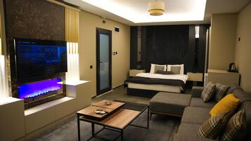 Basic Studio | Living area | 64-inch TV with digital channels, fireplace