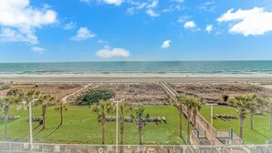 A beach view with a boardwalk, palm trees, and a clear sky. - Oceanfront w/ Indoor Waterparks at Dunes Village! (Myrtle Beach)