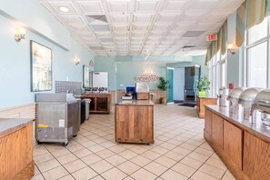 A hotel lobby with a reception desk, a coffee station, and a buffet area. - Luxe Oceanfront @ Seawatch Resort! (Horry County)