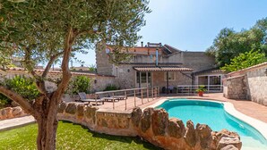 A stone villa with a swimming pool, outdoor seating, and a view of the surrounding landscape. - Nice home in Maria de la Salut (Maria de la Salut)