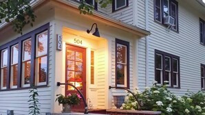 A two-story house with a red door and the number 504.