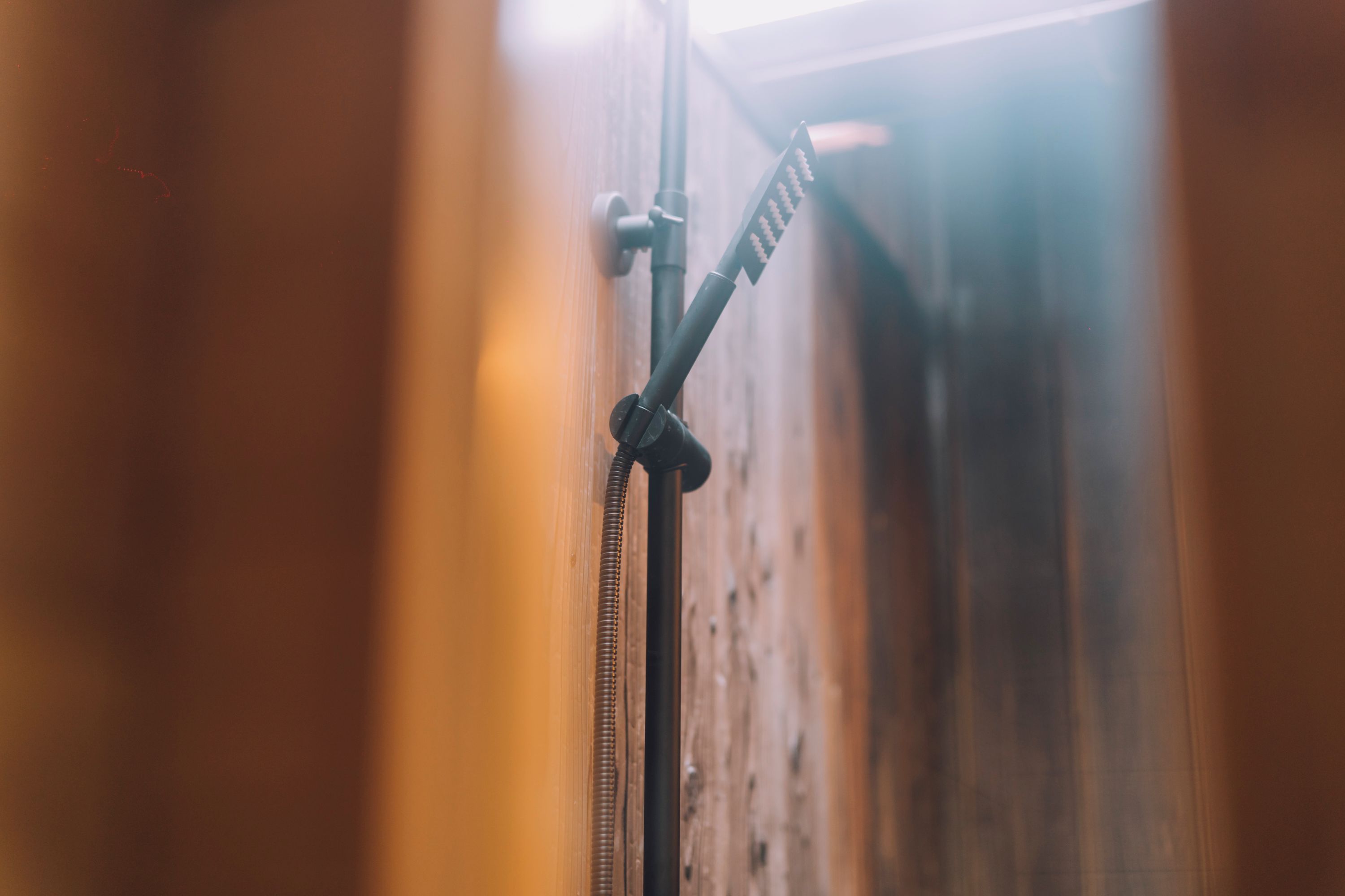 A microphone stand in a wooden room.