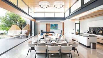 A spacious dining area with a long table set for six, surrounded by modern chairs.