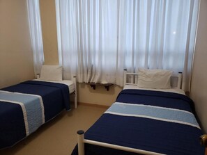 Private room with two single beds and shared bathroom