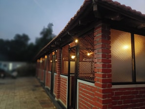 A row of brick buildings with large windows and a tiled roof. - Hotel Radhma Residency (Udupi)