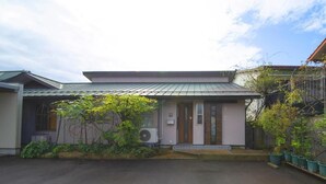 A residential building with a sloped roof, a front door, and a small porch area. - Shukubou Shinsen (Kanazawa)