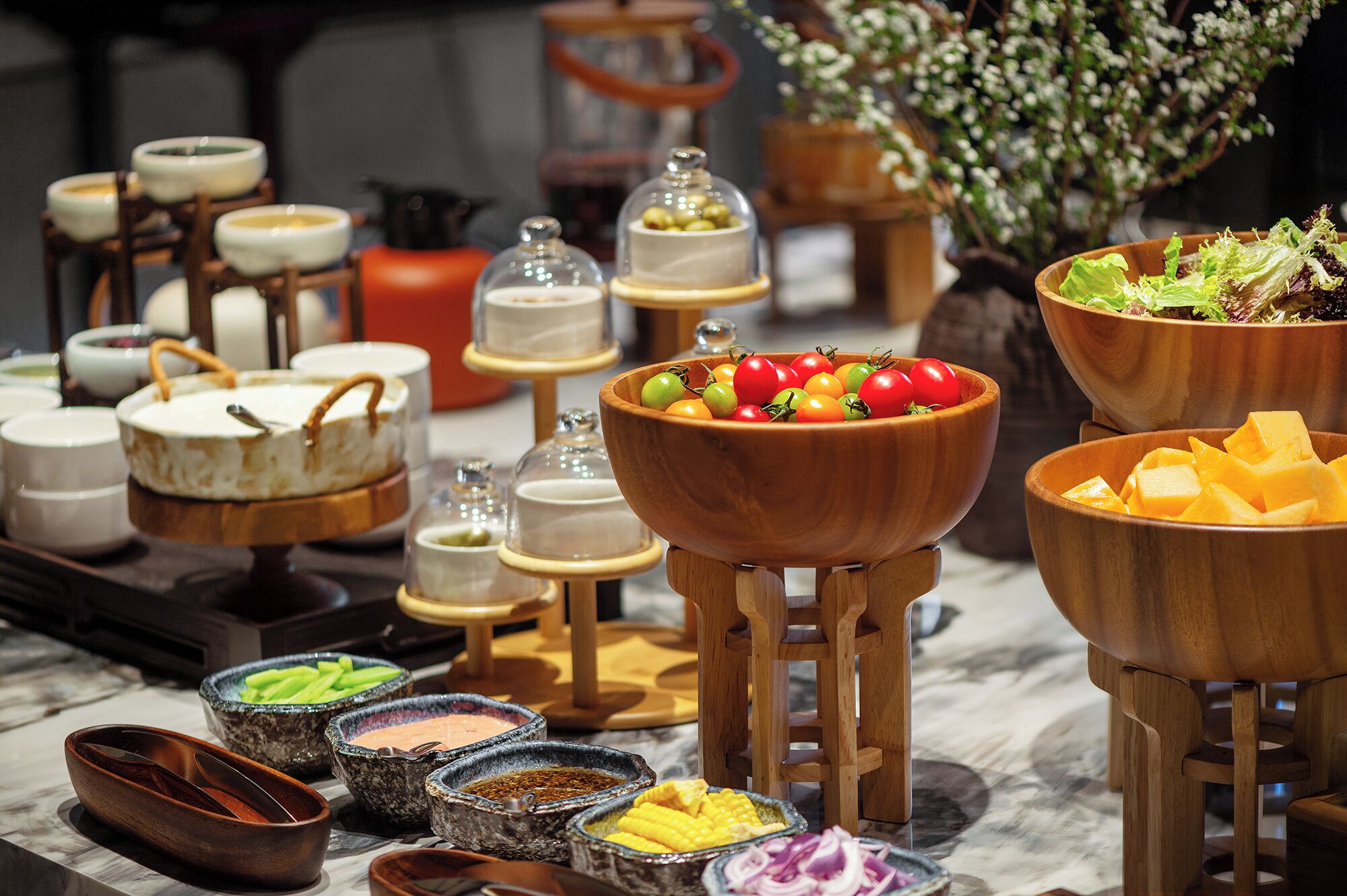 A buffet with various food items and condiments.