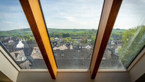 A view through a skylight with a rural landscape and buildings in the distance. - Bowling Fell Cottage -  Kendal Townhouse with Views (Kendal)
