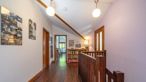 Un escalier en bois, doté d’une rampe, menant à un palier.