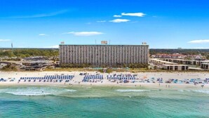 Un grand hôtel à plusieurs étages, situé en bord de mer.