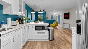 A modern kitchen with white cabinets, a built-in microwave, and a stainless steel refrigerator. - Sleeps 20~Heated Pool~Pickleball~Hot Tub~Fire Pit (Largo)