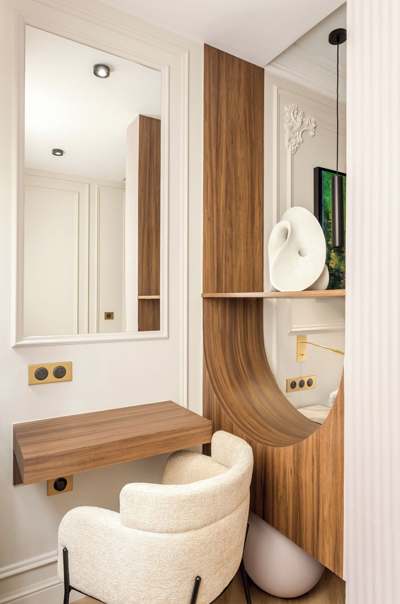 A modern bathroom with a wooden vanity, a white chair, and a mirror.