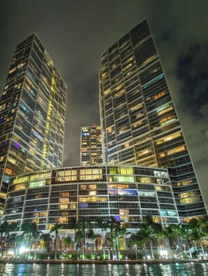 A high-rise hotel with multiple floors, large windows, and a waterfront view.