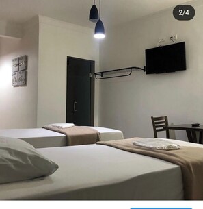 Twin Room, City View | Desk, laptop workspace, blackout drapes, iron/ironing board