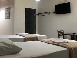 Twin Room, City View | Desk, laptop workspace, blackout drapes, iron/ironing board