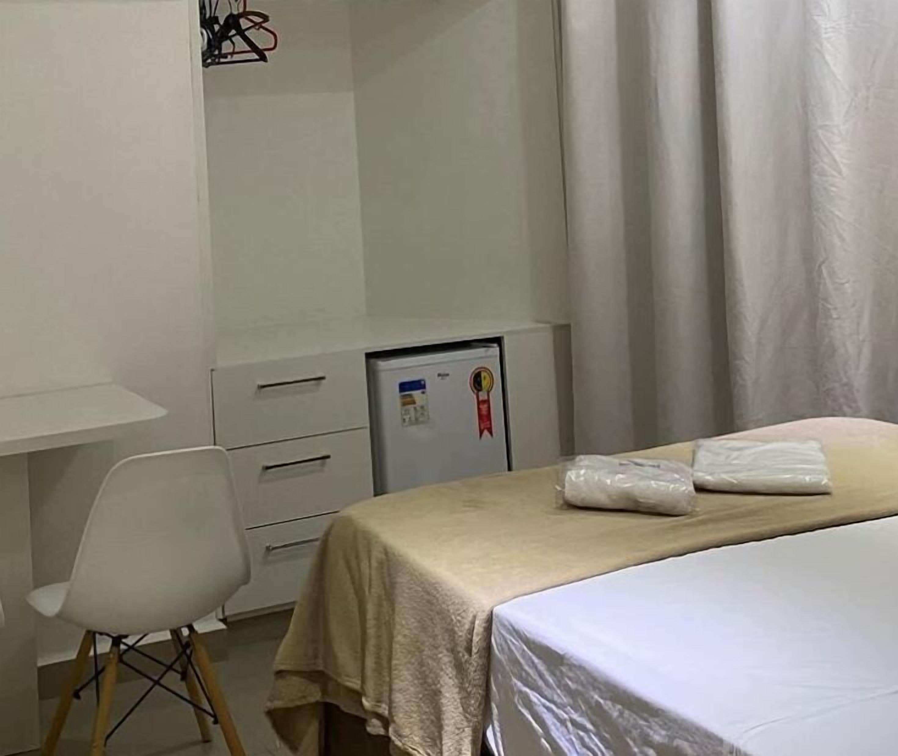 Desk, laptop workspace, blackout drapes, iron/ironing board