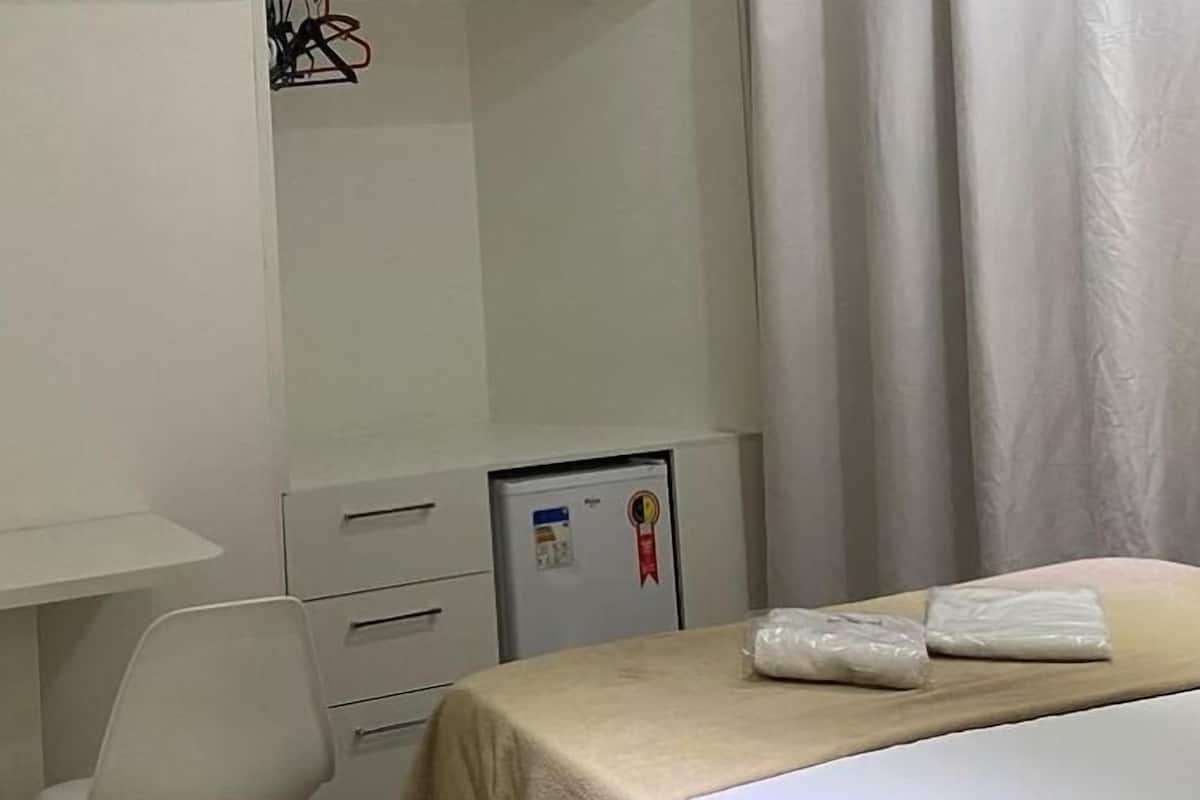 Desk, laptop workspace, blackout drapes, iron/ironing board