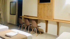 A hotel room with two beds, a wooden desk, and three chairs. - HOTEL GUARULHOS  (Guarulhos)