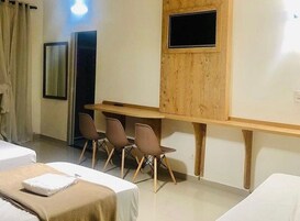 Triple Room, City View | Desk, laptop workspace, blackout drapes, iron/ironing board