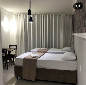 Twin Room, City View | Desk, laptop workspace, blackout drapes, iron/ironing board