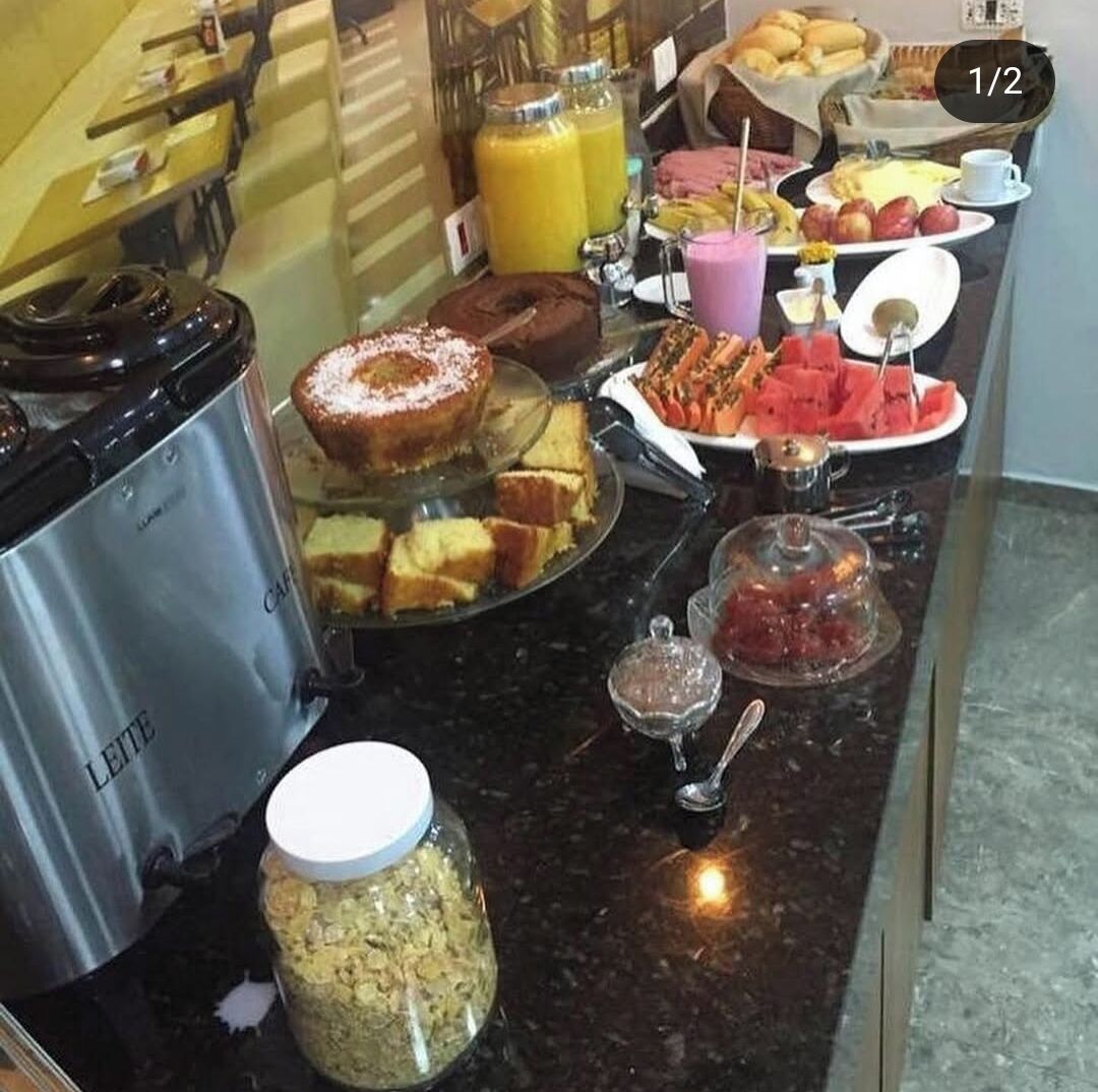 A breakfast buffet with various food items and a coffee maker.