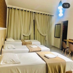 Triple Room, City View | Desk, laptop workspace, blackout drapes, iron/ironing board