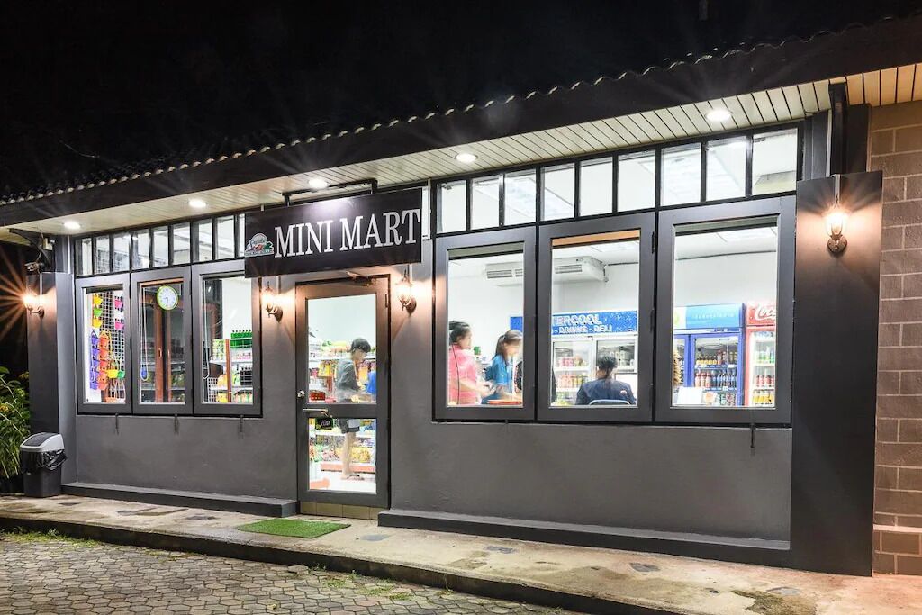 A Mini Mart with a dark facade, large windows, and a visible Coca-Cola refrigerator inside.