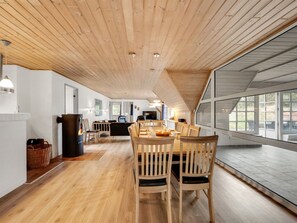 A spacious dining area with wooden furniture and a large window. - "Thiodver" - 850m from the sea by Interhome (Ringkøbing)