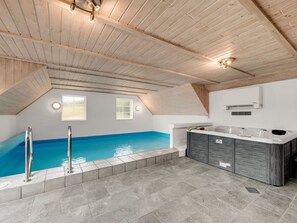 A modern bathroom with a built-in pool, a shower area, and a vanity with a mirror. - "Thiodver" - 850m from the sea by Interhome (Ringkøbing)
