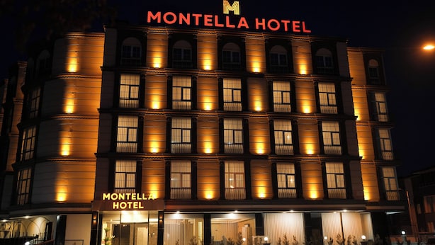 A multi-story hotel with illuminated signage reading "MONTELLA HOTEL" and "MONTELLA HOTEL" on the facade. - MONTELLA HOTEL (Elbistan)