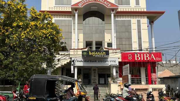 Un immeuble à plusieurs étages doté d’une entrée imposante, sur laquelle on peut lire l’inscription « Hôtel City Palace ».