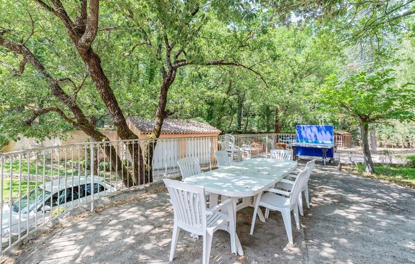 An outdoor patio with a table and chairs, a barbecue grill, and a car parked nearby. - Lovely home in Saint-Maximin-la-Saint (Saint-Maximin-la-Saint)