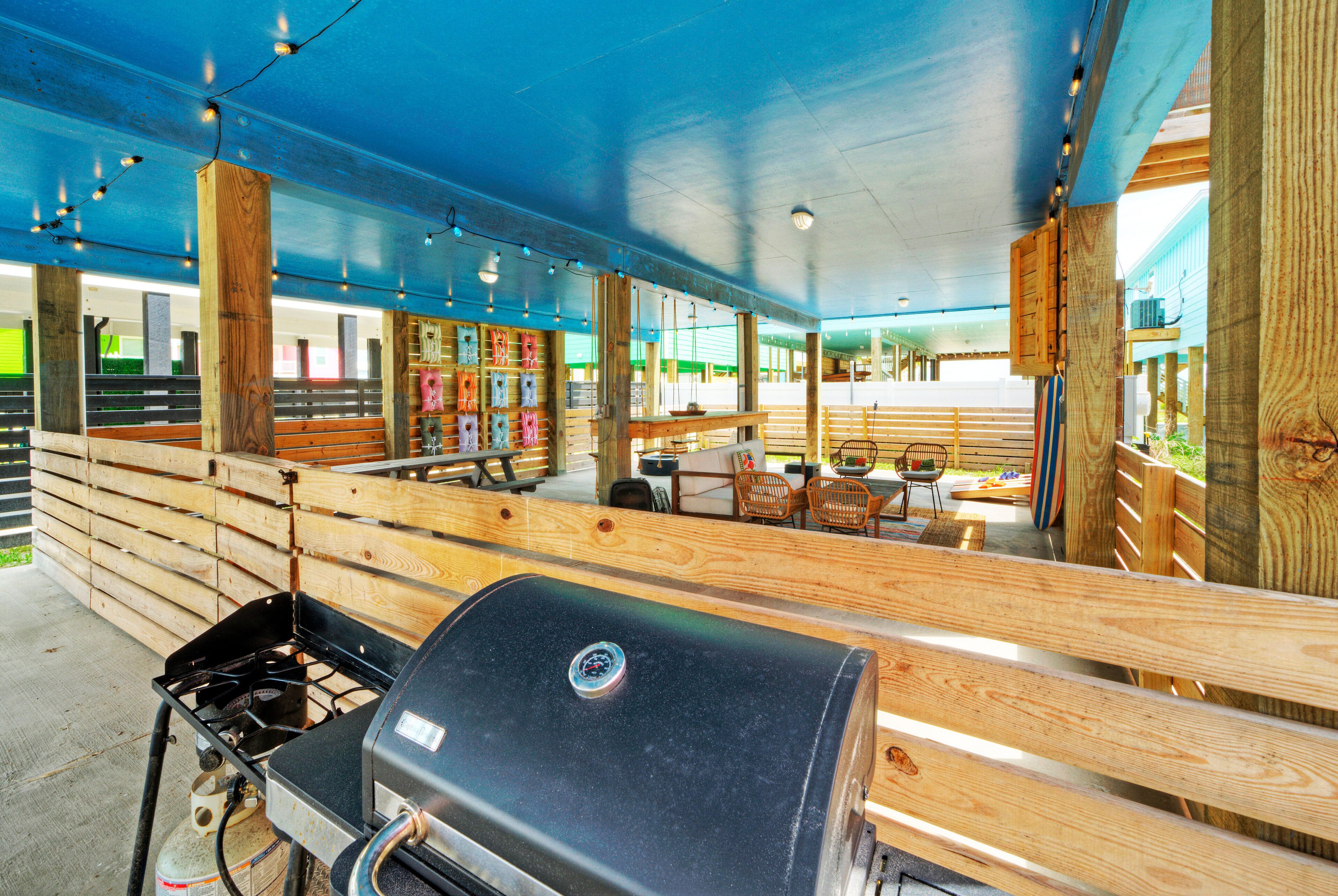 An outdoor seating area with wooden benches and a barbecue grill.