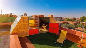 A children's play area with a slide, climbing wall, and a fenced play structure. - Chateau Nougat Marrakech (Tameslouht)