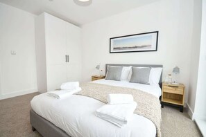 1 dormitorio, tabla de planchar con plancha, ropa de cama