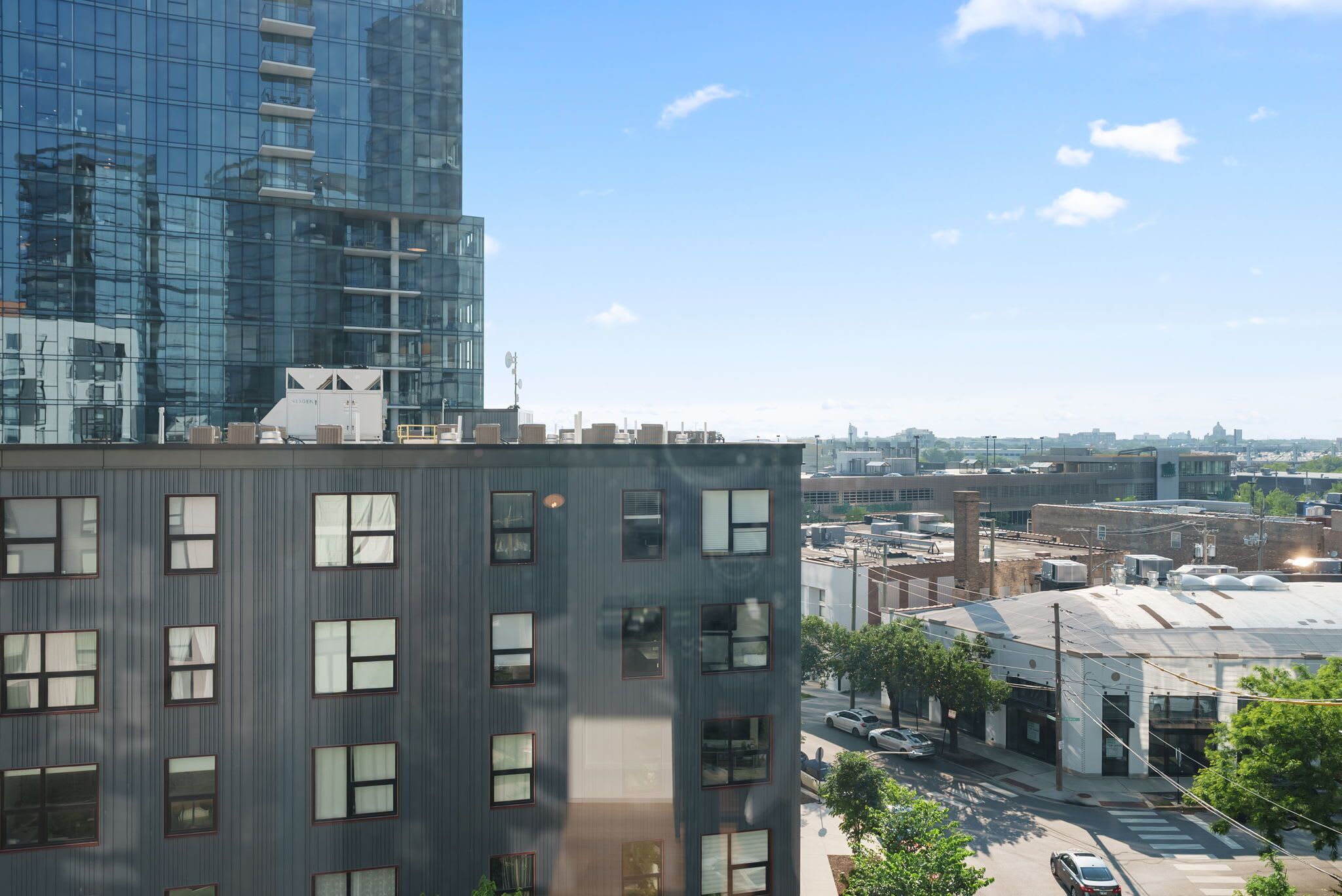 A multi-story building with a modern glass facade and a flat roof.